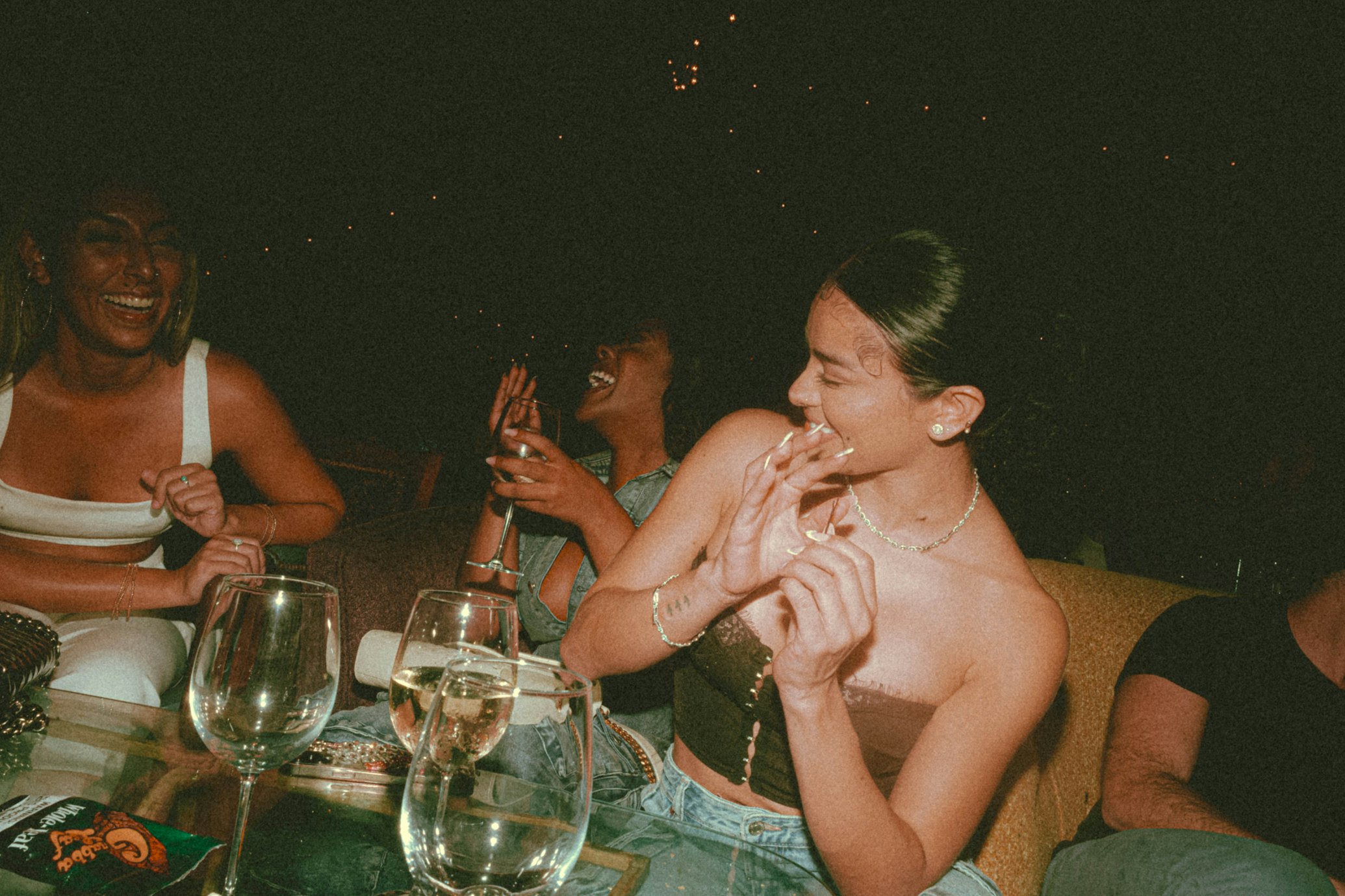 Group laughing and connecting at night on a Thrive retreat